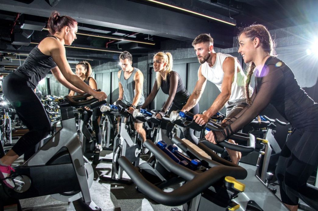 Happy gym members and staff celebrating